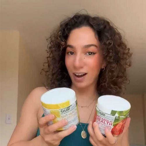 A GUMvees customer holding two jars of gummies