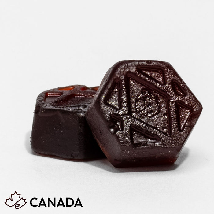 Two Metabolic Health gummies close up, showing the embossed GUMvees hexagon