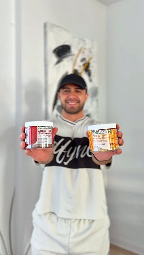 A GUMvees customer holding up two jars of gummies